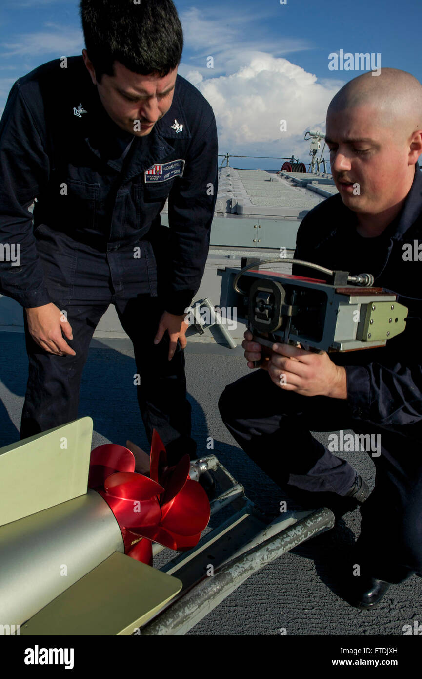 Sailors aboard the USS Carney (DDG 64) conduct maintenance on a MK 46 ...