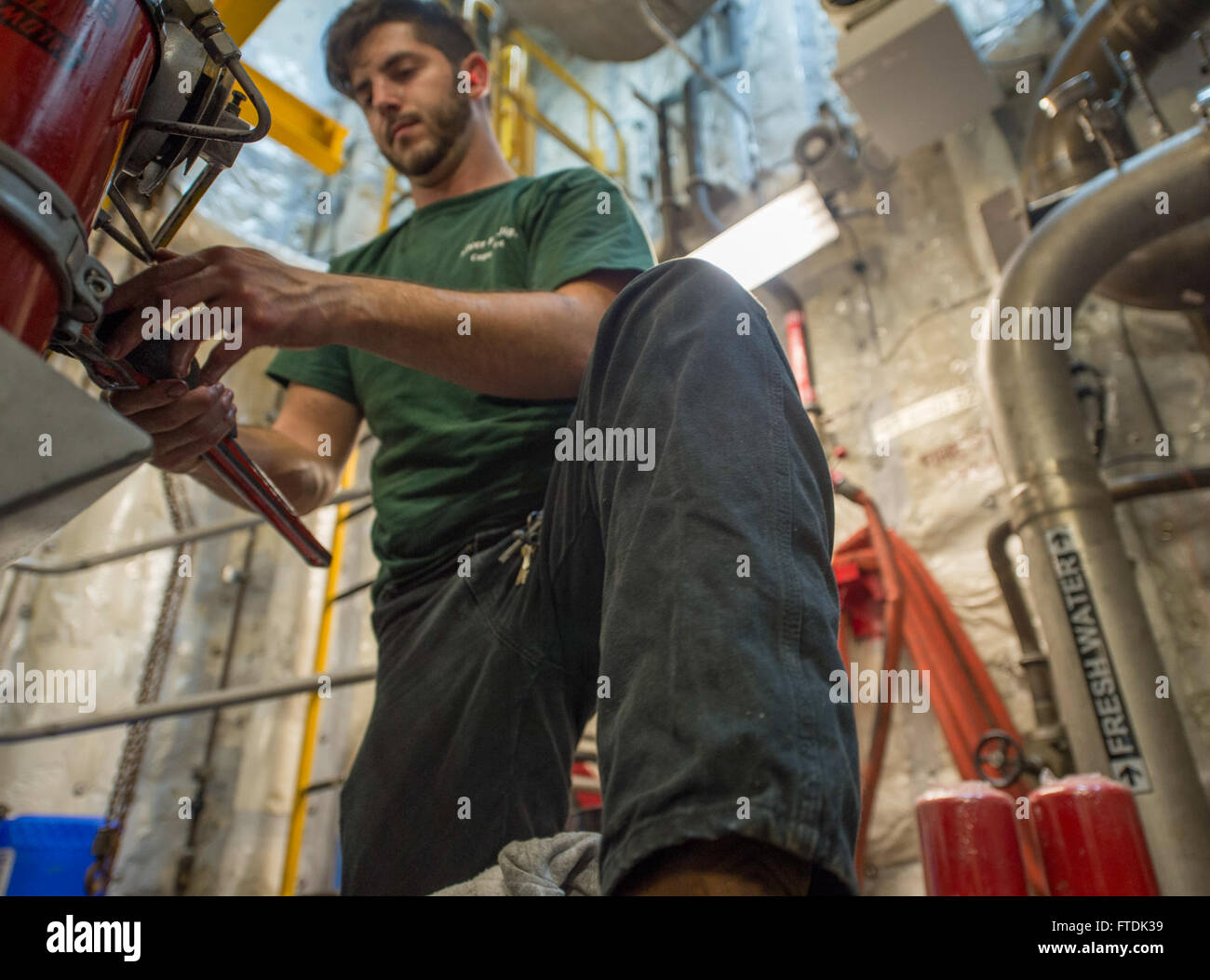 160104-N-WV703-020 ATLANTIC OCEAN (Jan. 4, 2016) 1st Assistant Engineer David Desousa, a civil service mariner, changes the final fuel filter aboard USNS Spearhead (T-EPF 1) Jan. 4, 2015. The Military Sealift Command expeditionary fast transport vessel USNS Spearhead is on a scheduled deployment to the U.S. 6th Fleet area of operations to support the international collaborative capacity-building program Africa Partnership Station. (U.S. Navy photo by Mass Communication Specialist 3rd Class Amy M. Ressler/Released) Stock Photo