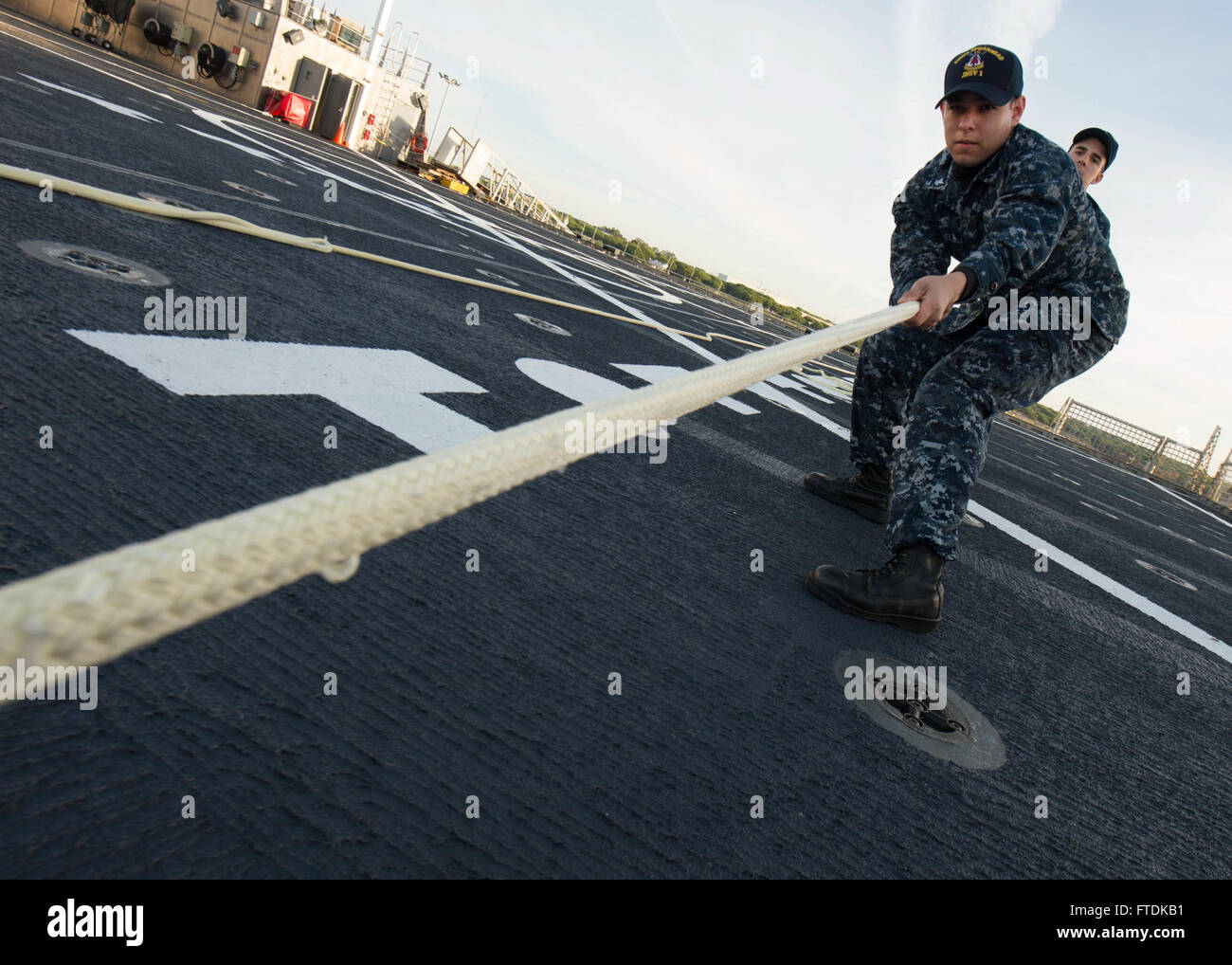 160113-N-QF605-024 ROTA, Spain (Jan. 13, 2016) Information Systems Technician (Submarines)  2nd Class Eric Favela heaves a mooring line during small boat operations aboard USNS Spearhead (T-EPF 1) Jan. 13, 2016. The Military Sealift Command expeditionary fast transport vessel USNS Spearhead is on a scheduled deployment to the U.S. 6th Fleet area of operations to support the international collaborative capacity-building program Africa Partnership Station. (U.S. Navy photo by Mass Communication Specialist 1st Class Amanda Dunford/Released) Stock Photo
