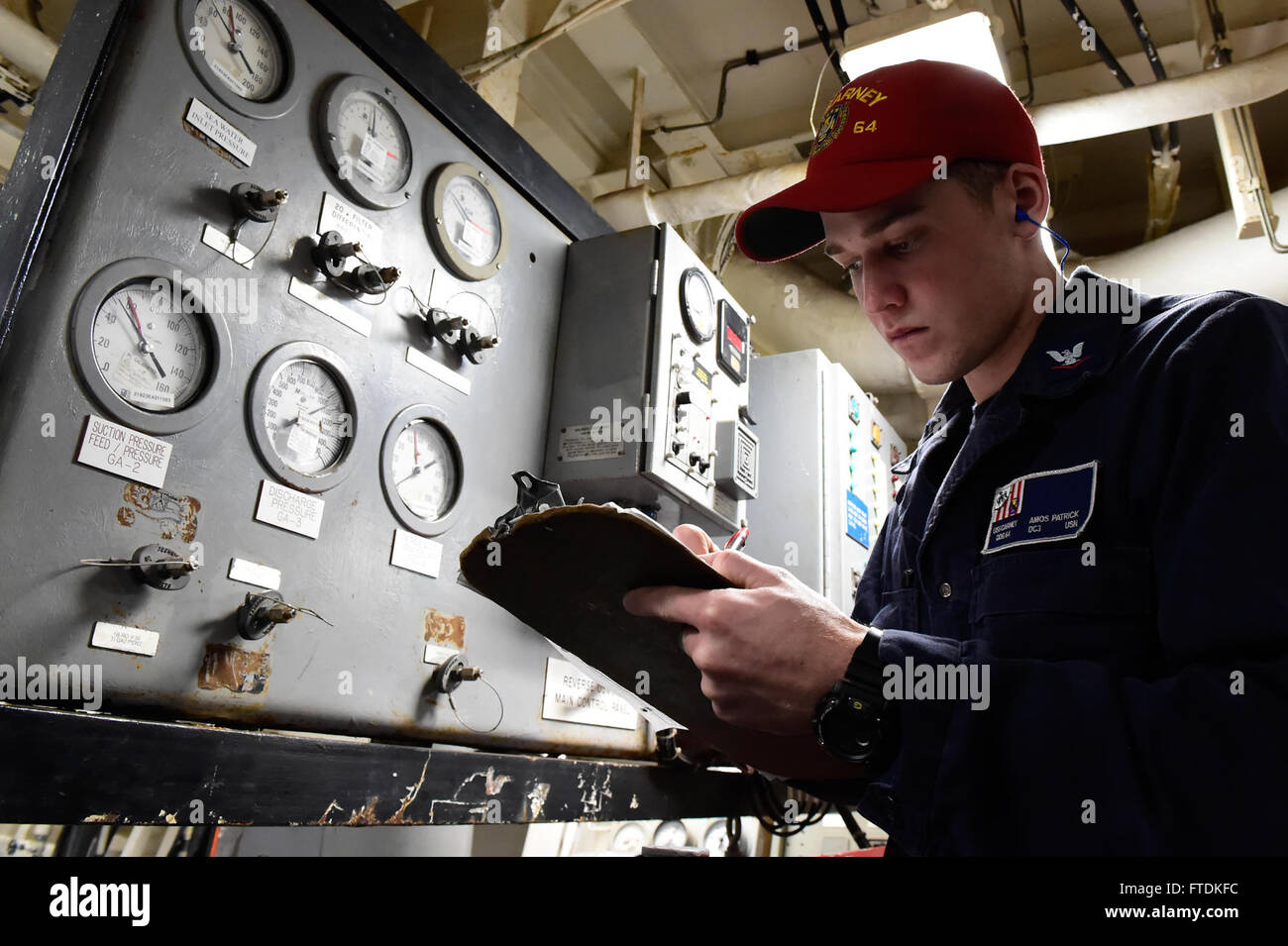 160122-N-FP878-223 MEDITERRANEAN SEA (Jan. 22, 2016) Damage Controlman 3rd Class Amos Patrick, from Salyersville, Kentucky, checks gauges while on auxiliary systems monitor watch aboard USS Carney (DDG 64) Jan. 22, 2016. Carney, an Arleigh Burke-class guided-missile destroyer, forward deployed to Rota, Spain, is conducting a routine patrol in the U. S. 6th Fleet area of operations in support of U.S. national security interests in Europe. (U.S. Navy photo by Mass Communication Specialist 1st Class Theron J. Godbold/Released) Stock Photo