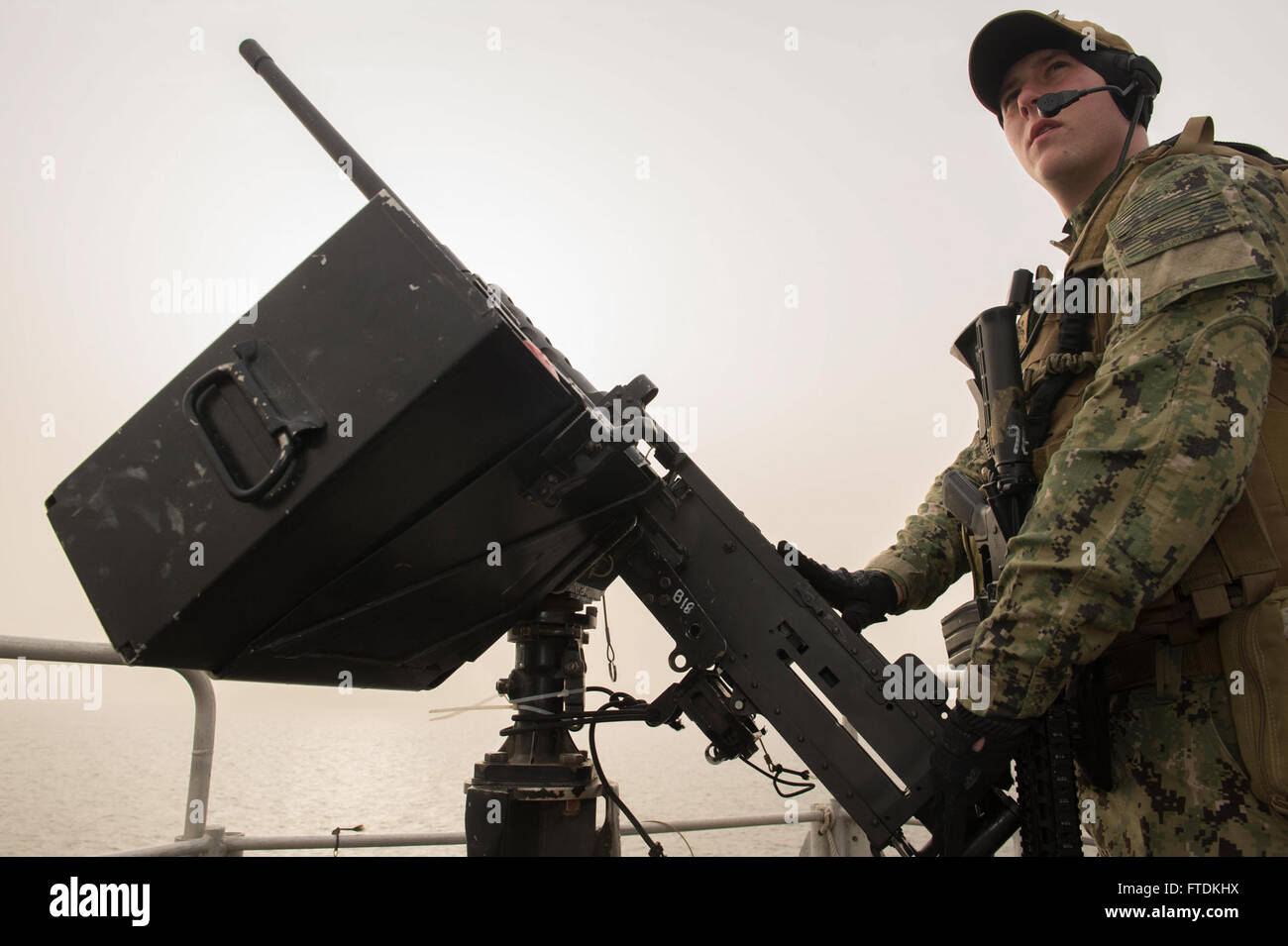 160126-N-WV703-007 ATLANTIC OCEAN (Jan. 26, 2016) Master-at-Arms 3rd Class Travis Moose, from Hazleton, Pennsylvania, stands a .50-caliber machine gun watch as a member of the embarked security team aboard USNS Spearhead (T-EPF 1) Jan. 26, 2016. The Military Sealift Command expeditionary fast transport vessel USNS Spearhead is on a scheduled deployment in the U.S. 6th Fleet area of operations to support the international collaborative capacity-building program Africa Partnership Station. (U.S. Navy photo by Mass Communication Specialist 3rd Class Amy M. Ressler/Released) Stock Photo