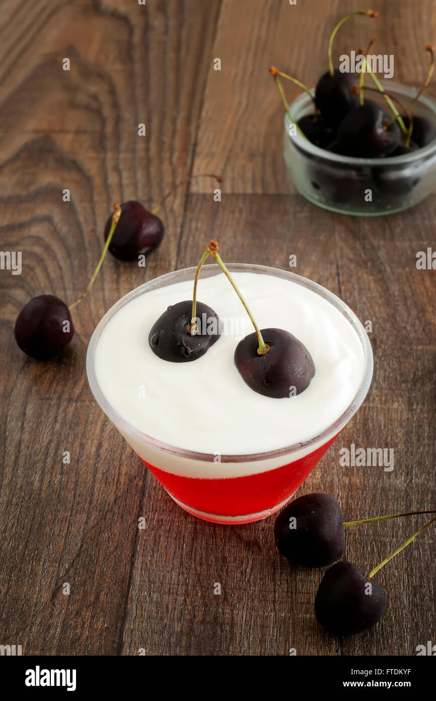 Summer refreshing dessert with black cherries, yogurt and red jelly. Stock Photo