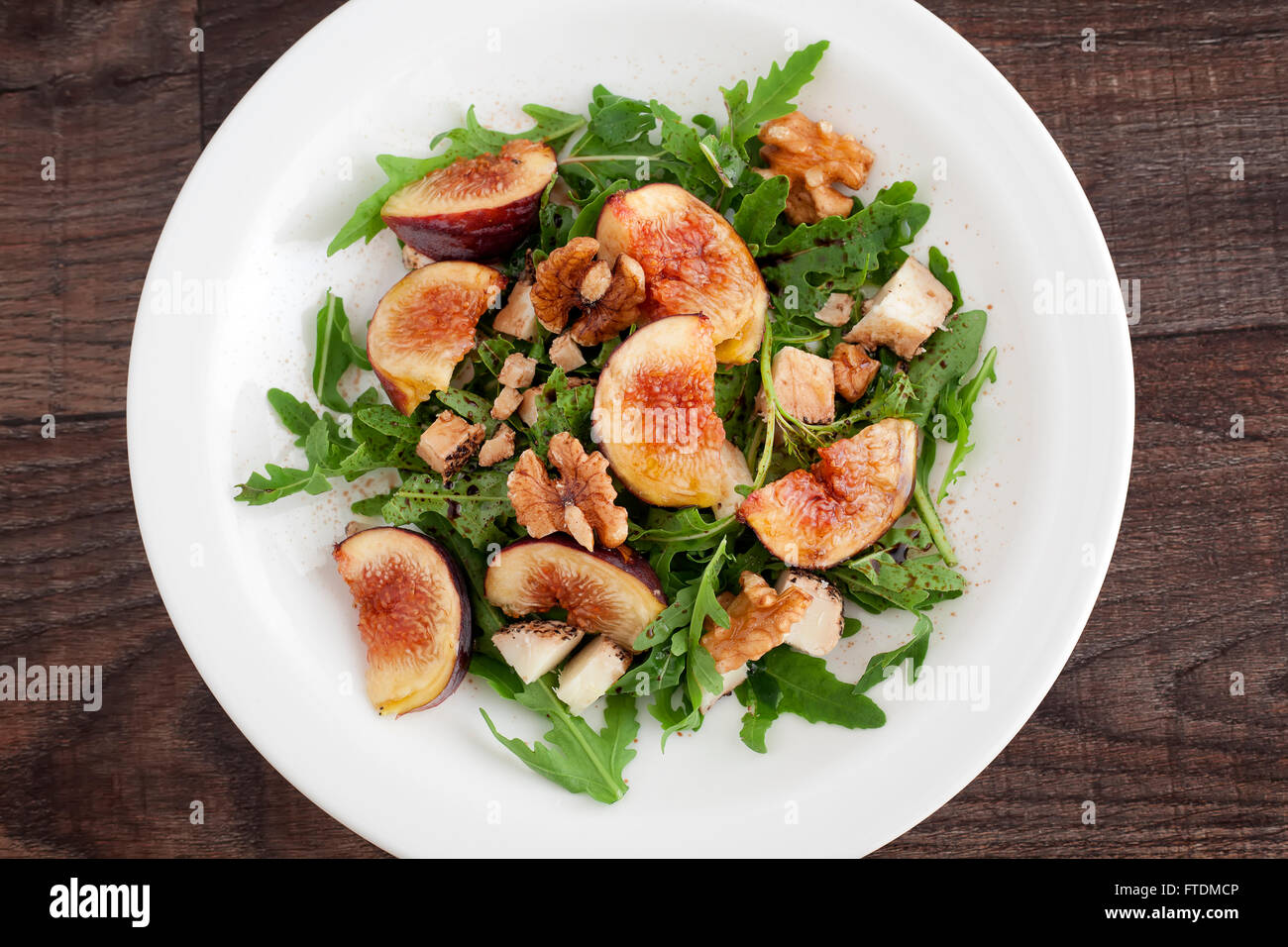 Fig with rucola, a summer mediterranean dish in a white plate. Stock Photo