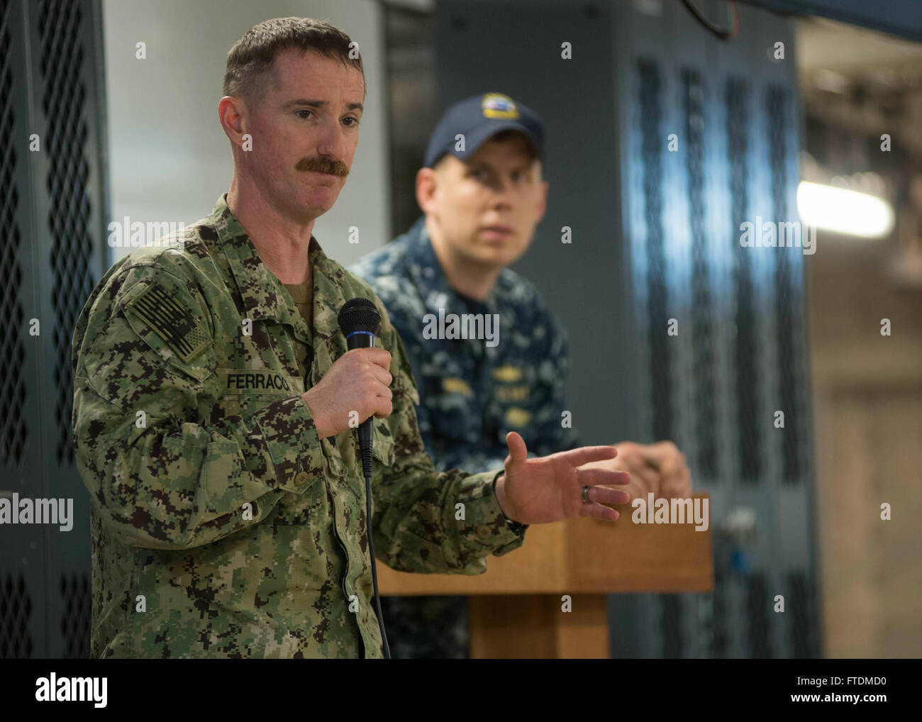 160215-N-WV703-040 SEKONDI, Ghana (Feb. 15, 2016) Cmdr. Tim Ferracci,  Africa Maritime Law Enforcement Partnership mission commander, addresses Ghanaian navy and combined boarding team members along with U.S. Navy and U.S. Coast Guard during an exercise debrief aboard USNS Spearhead (T-EPF 1) Feb. 15, 2016. The Military Sealift Command expeditionary fast transport vessel USNS Spearhead is on a scheduled deployment in the U.S. 6th Fleet area of operations to support the international collaborative capacity-building program Africa Partnership Station. (U.S. Navy photo by Mass Communication Speci Stock Photo