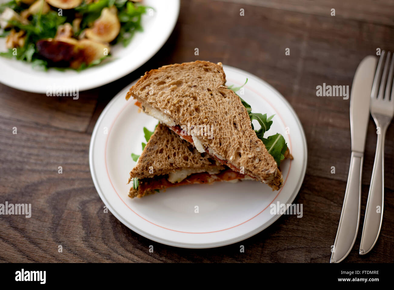 Italian salami and sheep cheese sandwich with brown bread. Stock Photo