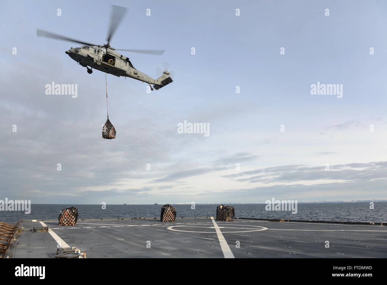 160229-N-QJ850-524 NORTH SEA (Feb. 29, 2016)An SH-60 Sea Hawk performs a vertical replenishment (VERTREP) aboard the Whidbey Island-class dock landing ship USS Fort McHenry (LSD 43) in Trondheim, Norway. Fort McHenry is participating in Exercise Cold Response 2016, a Norwegian invitational, NATO Military Training and Exercise Program (MTEP), Article 4 live exercise with invitations to all NATO and select Partnership for Peace nations that will involve approximately 16,000 troops from 12 countries. (U.S. Navy photo by Mass Communication Specialist 3rd Class Andrew Murray/Released) Stock Photo