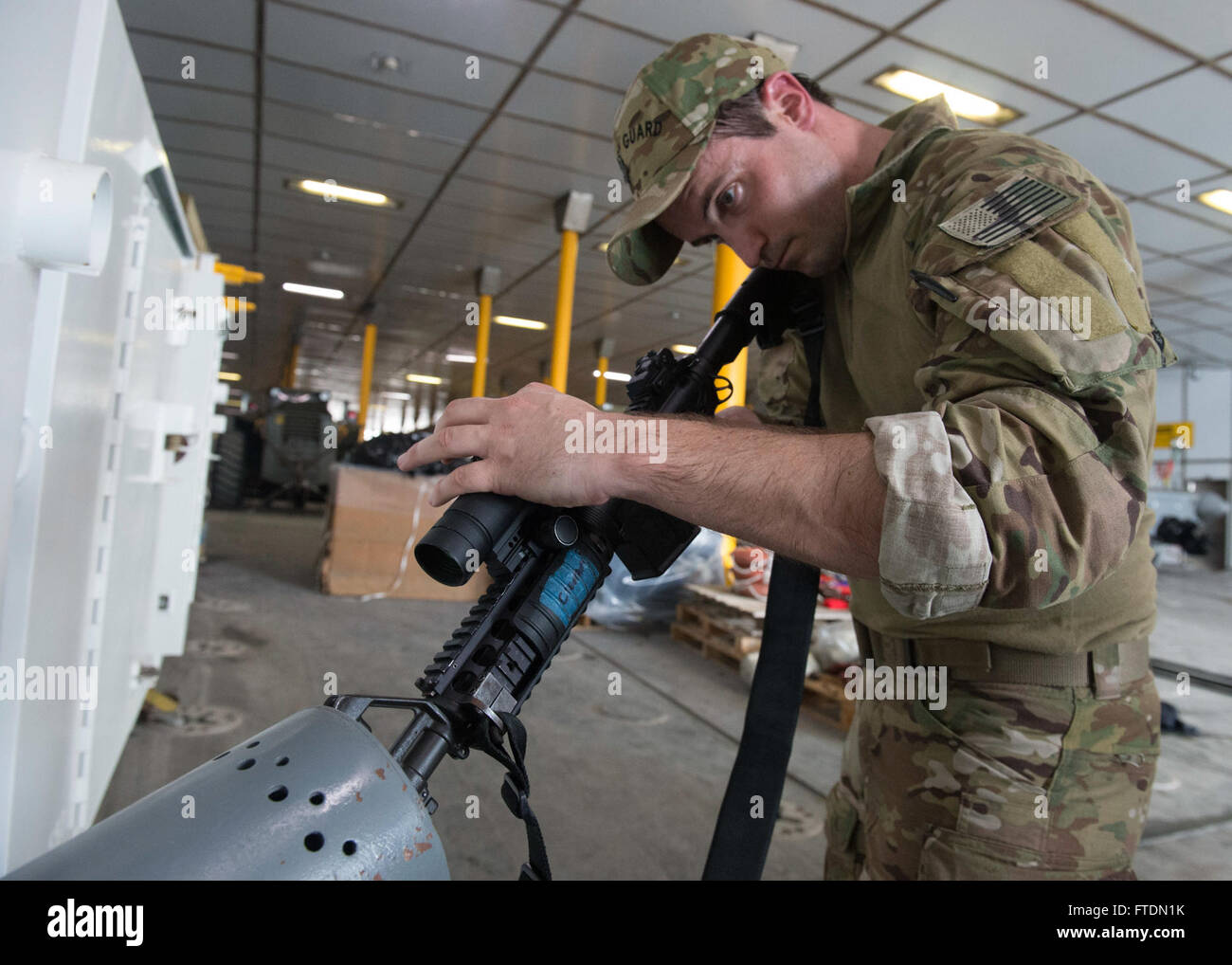 160303-N-QF605-296 ATLANTIC OCEAN (March 3, 2016) Maritime Enforcement Specialist 1st Class Glenn Hyzak, a U.S. Coast Guard Law Enforcement Detachment member, performs weapons maintenance aboard USNS Spearhead (T-EPF 1), March 3, 2016. The Military Sealift Command expeditionary fast transport vessel USNS Spearhead is on a scheduled deployment to the U.S. 6th Fleet area of operations to support the international collaborative capacity-building program Africa Partnership Station. (U.S. Navy photo by Mass Communication Specialist 1st Class Amanda Dunford/Released) Stock Photo