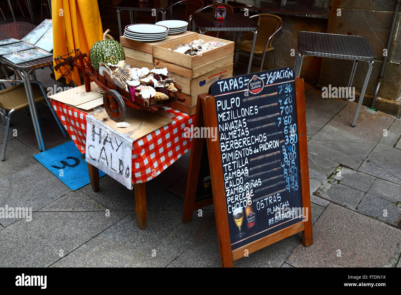 Spanish language menu with prices in Euros outside typical seafood restaurant / cafe, Vigo, Galicia, Spain Stock Photo