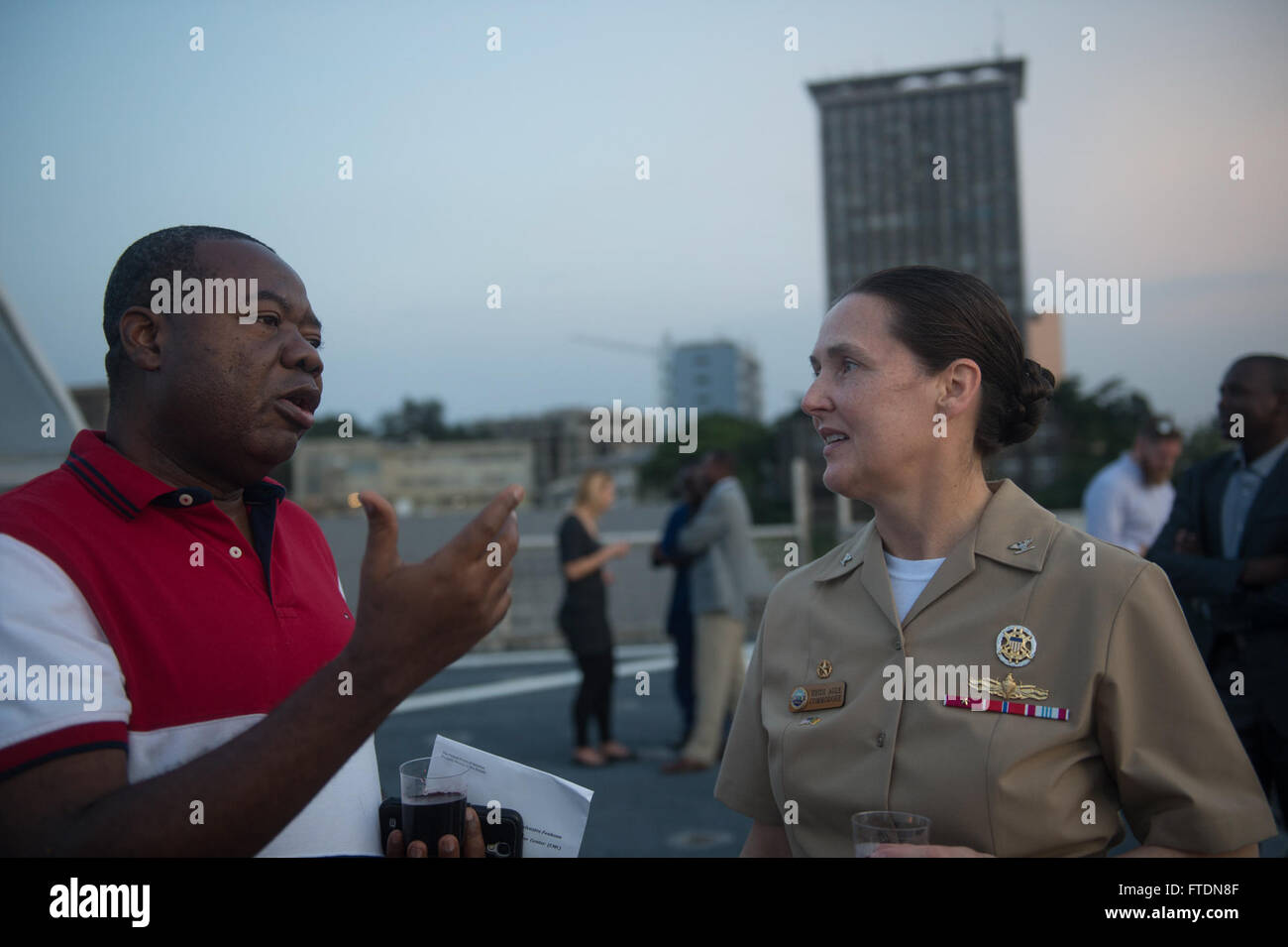 160312-N-WV703-021  DOUALA, Cameroon (March 12, 2016) - Multinational Center of Coordination Chief, Mbah Sylvester Fonkoua (left) speaks with Capt. Heidi Agle, commodore, Military Sealift Command Europe and Africa aboard USNS Spearhead (T-EPF 1) during African Maritime Law Enforcement Partnership Cameroon closing ceremony March 12, 2016. The Military Sealift Command expeditionary fast transport vessel USNS Spearhead is on a scheduled deployment in the U.S. 6th Fleet area of operations to support the international collaborative capacity-building program Africa Partnership Station. (U.S. Navy ph Stock Photo