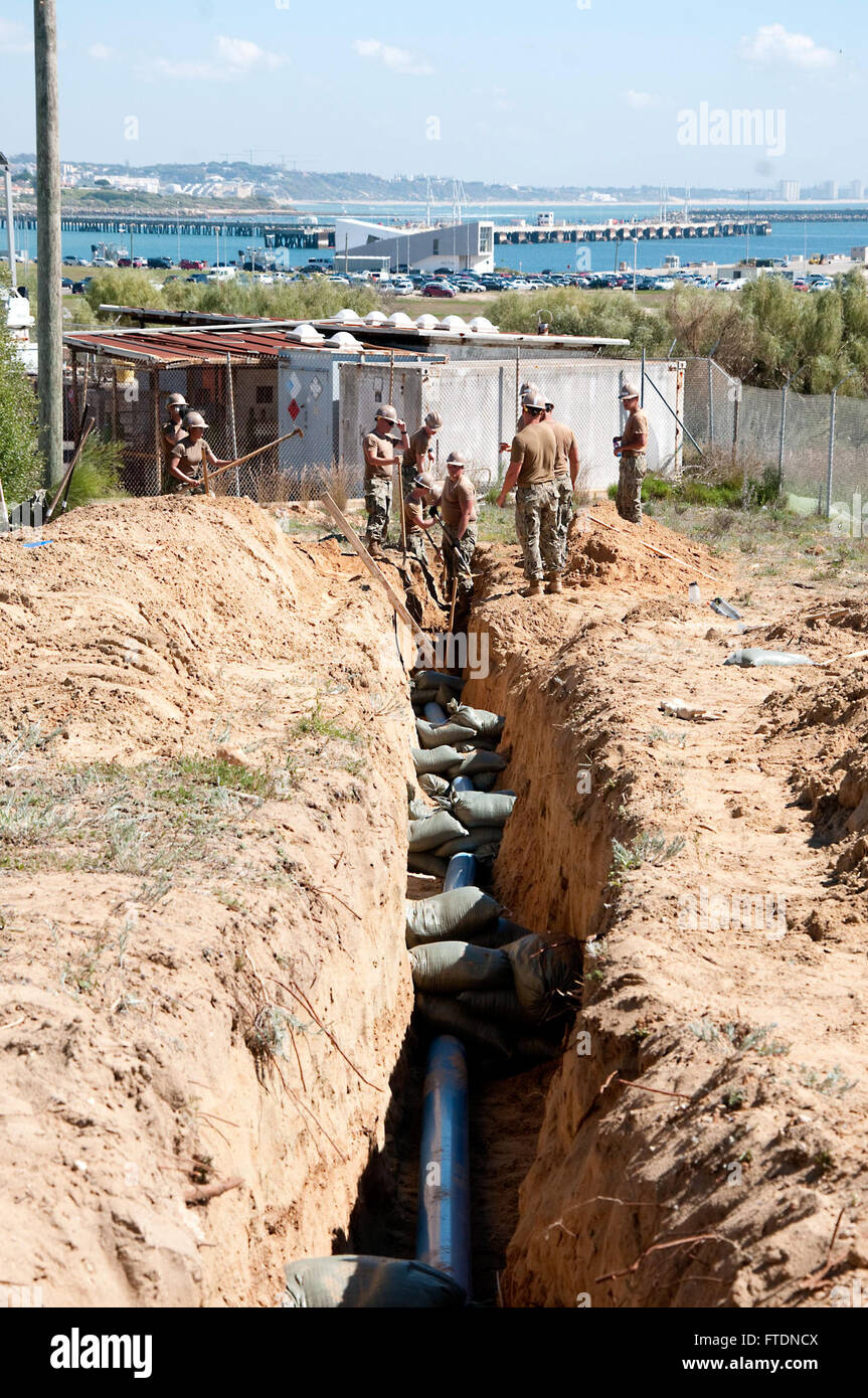 160316-N-VJ282-008 ROTA, Spain (March 16, 2016) Seabees assigned to Naval Mobile Construction Battalion 133 dig a trench for a water supply line during the construction of the Shipboard Electronic Systems Evaluation Facility (SESEF) at Naval Station Rota March 16, 2016. The SESEF will provide test and evaluation services to the Navy, Coast Guard, Military Sealift Command as well as allied foreign navies. (U.S. Navy photo by Mass Communication Specialist 1st Class Brian Dietrick/Released) Stock Photo