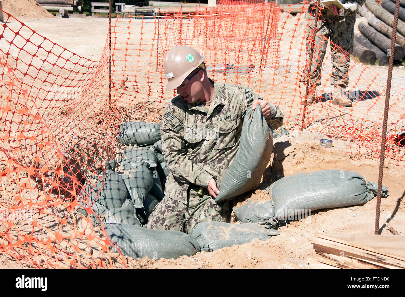 160316-N-VJ282-002 ROTA, Spain (March 16, 2016) Builder Constructionman Cody Brost, assigned to Naval Mobile Construction Battalion 133, fills a hole with sandbags during the construction of the Shipboard Electronic Systems Evaluation Facility (SESEF) at Naval Station Rota March 16, 2016. The SESEF will provide test and evaluation services to the Navy, Coast Guard, Military Sealift Command as well as allied foreign navies. (U.S. Navy photo by Mass Communication Specialist 1st Class Brian Dietrick/Released) Stock Photo