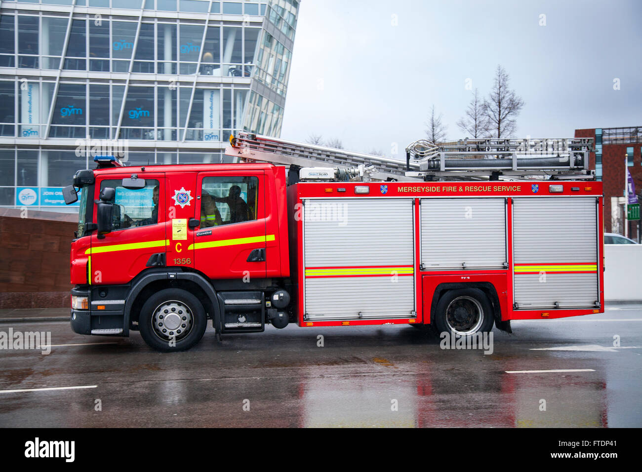 Merseyside Fire & Rescue, fire, truck, emergency stationery vehicle, rescue, car, firefighter, safety, engine, red, fire truck, transportation, equipment, transport, fireman, danger, department, service, firetruck responding to an emergency on The Strand, Liverpool, UK Stock Photo