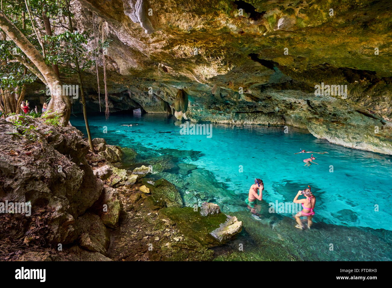 Tourist relaxing in Two Eyes Cenote (Cénote Dos Ojos), Yucatan, Mexico. Stock Photo