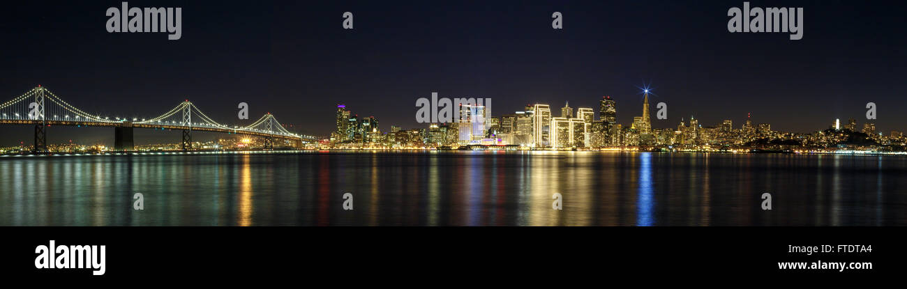 San Francisco skyline at night with city and Bay Bridge lights Stock Photo