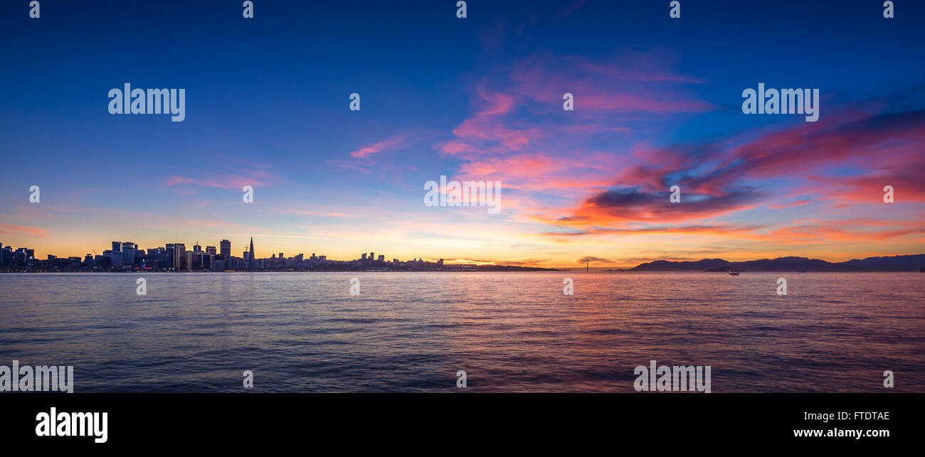 San Francisco skyline at sunset with a silhouette of skyscrapers with dramatic clouds Stock Photo