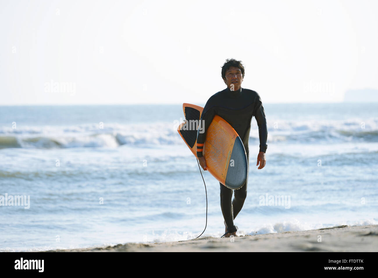 Japanese surfer walking on the beach Stock Photo Alamy