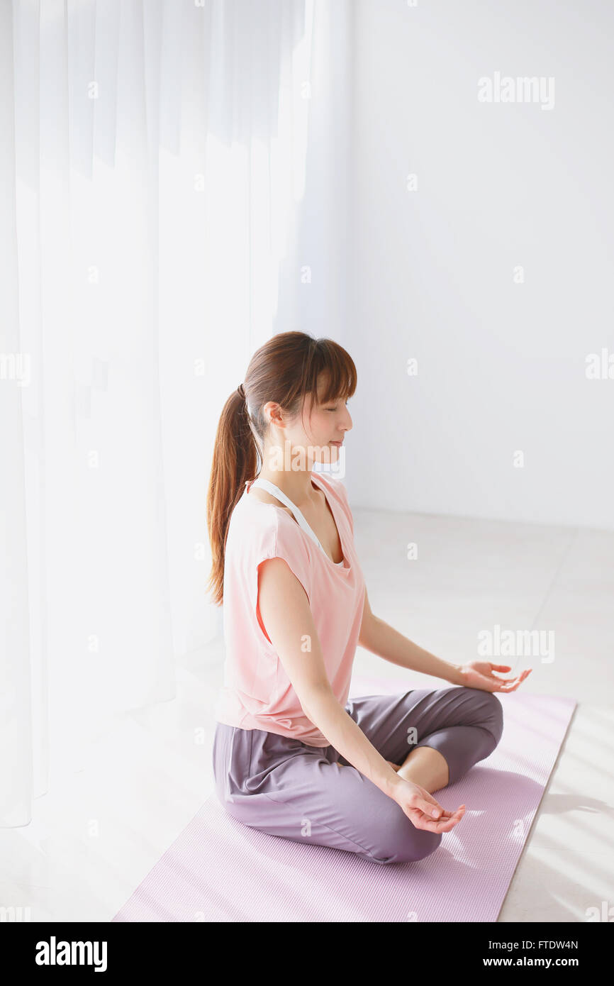 Young Japanese woman practicing yoga Stock Photo - Alamy