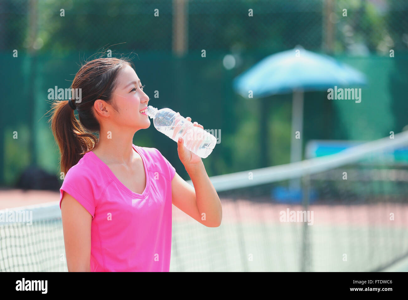 Young Japanese tennis player on the court Stock Photo Alamy