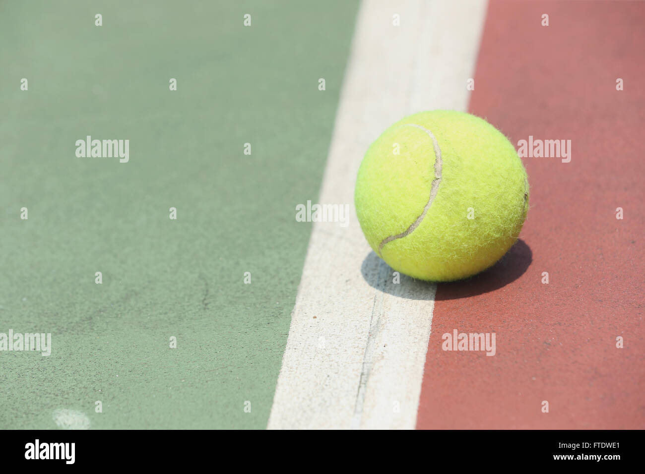 Tennis ball on court Stock Photo