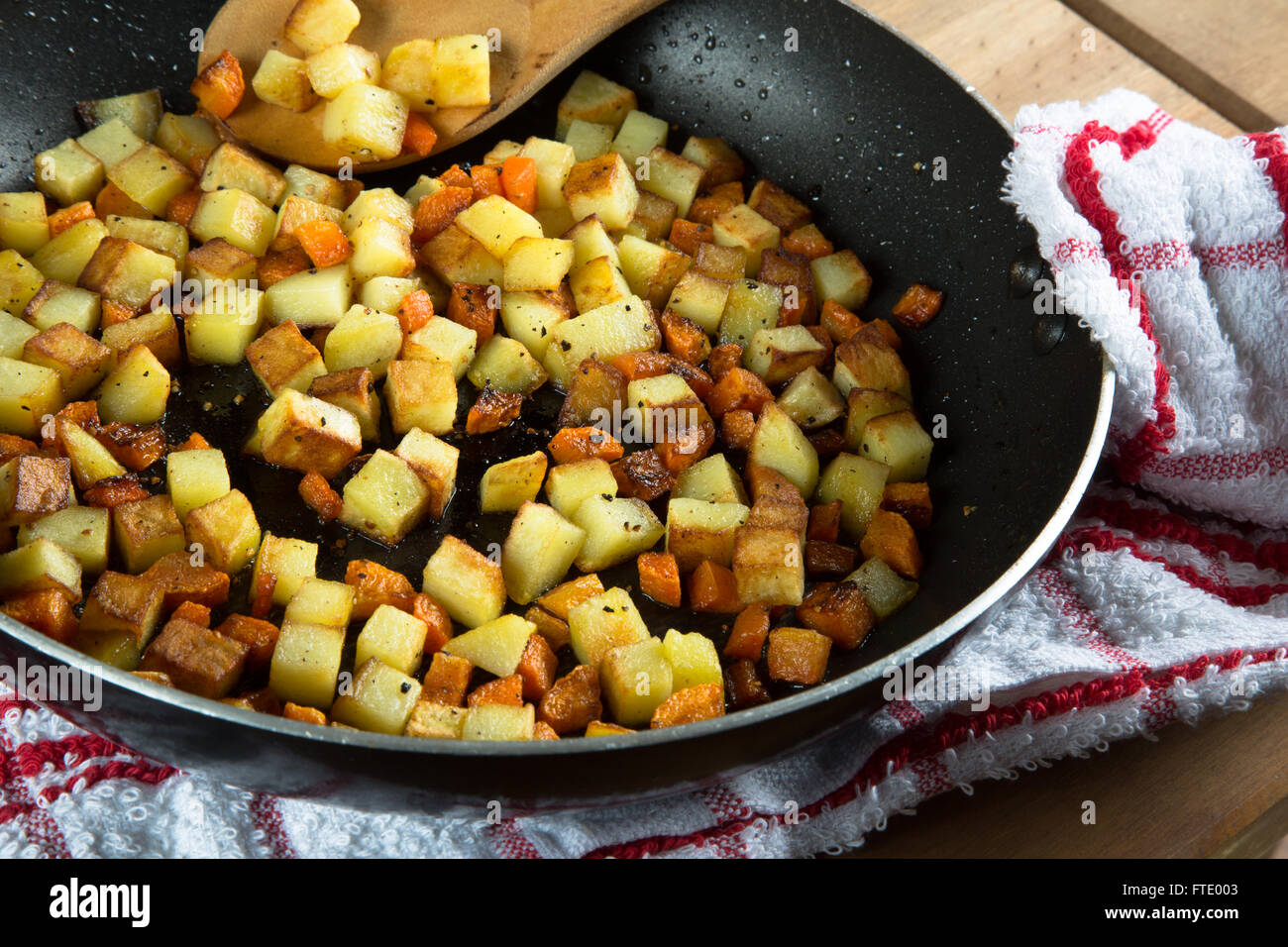 A pan/skillet of sautéed diced vegetables (Potato and Carrot Stock