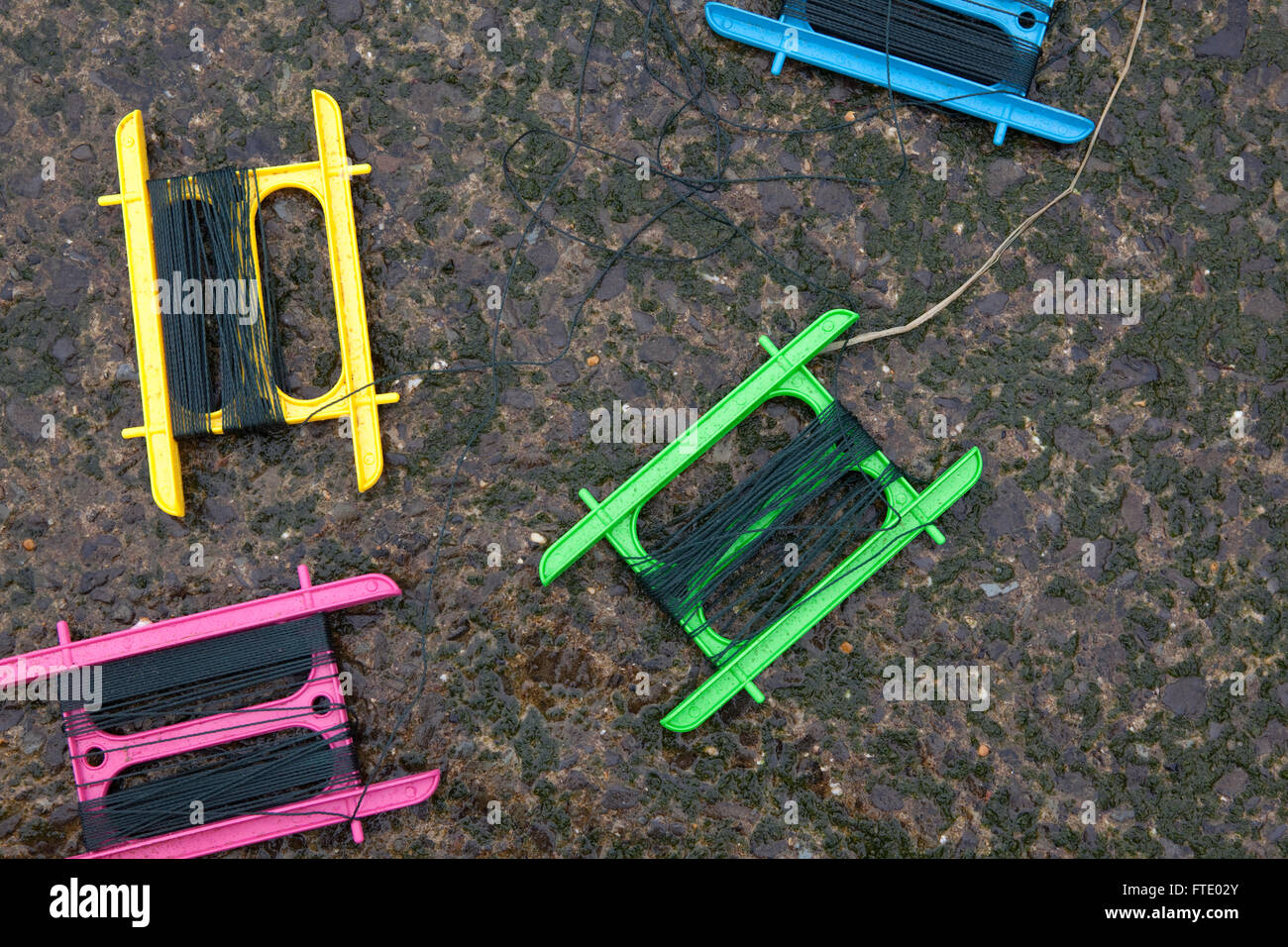 Brightly coloured crab lines sit on a quay side in a british holiday