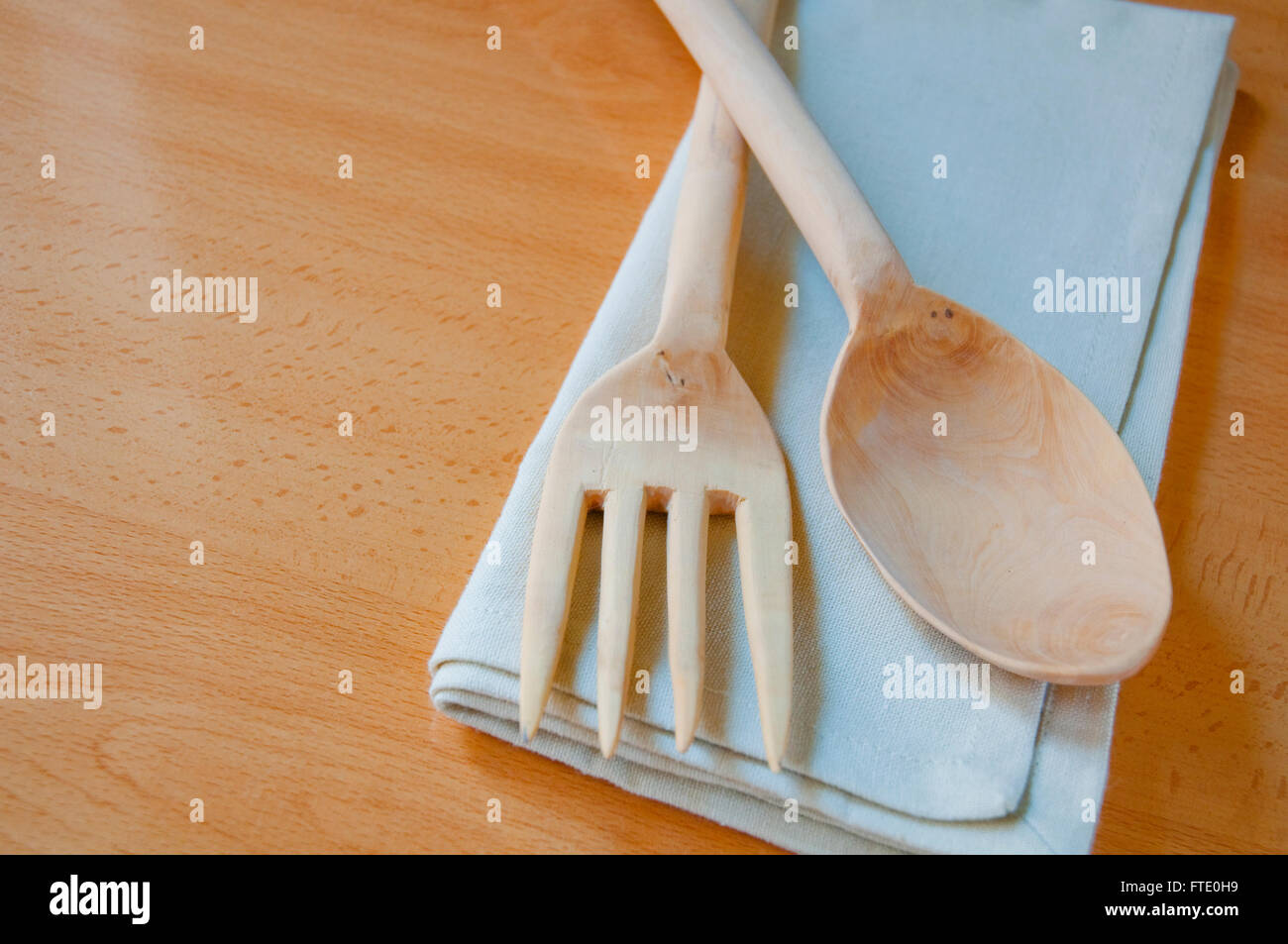 Wooden spoon and fork on napkin. Stock Photo
