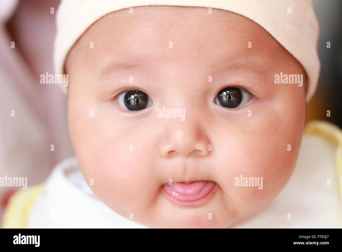 Cute baby looking at the camera Stock Photo