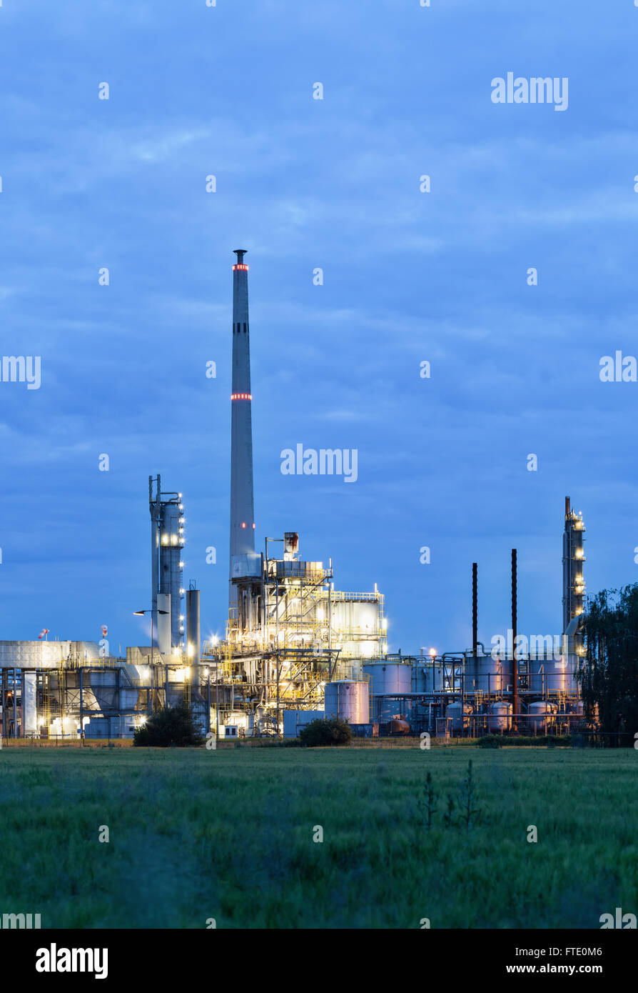 View on illuminated operational chemical plant in twilight Stock Photo