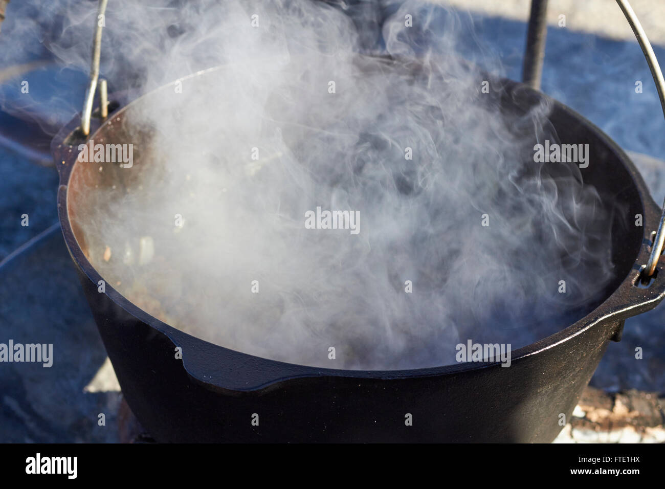 cooking in a cast iron pot over an open fire, cowboy style, Alpine, Texas, USA Stock Photo