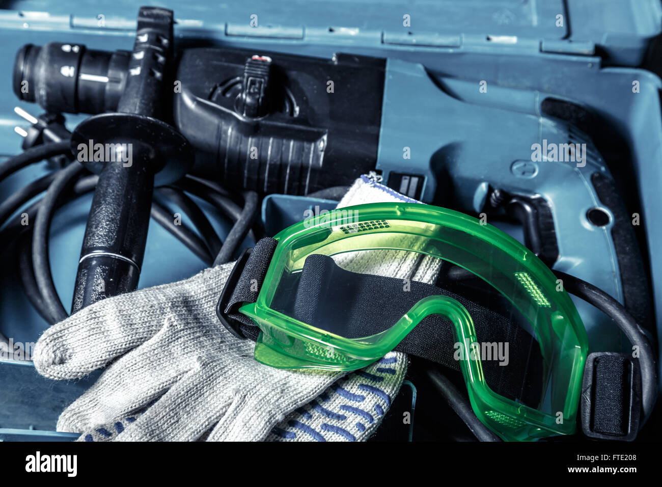 Drill, gloves and goggles in the box Stock Photo
