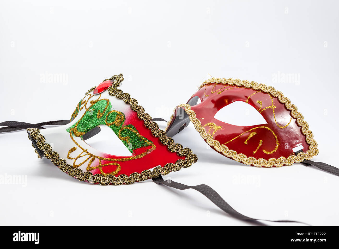 an carnival mask on an white background with black ribbons Stock Photo ...