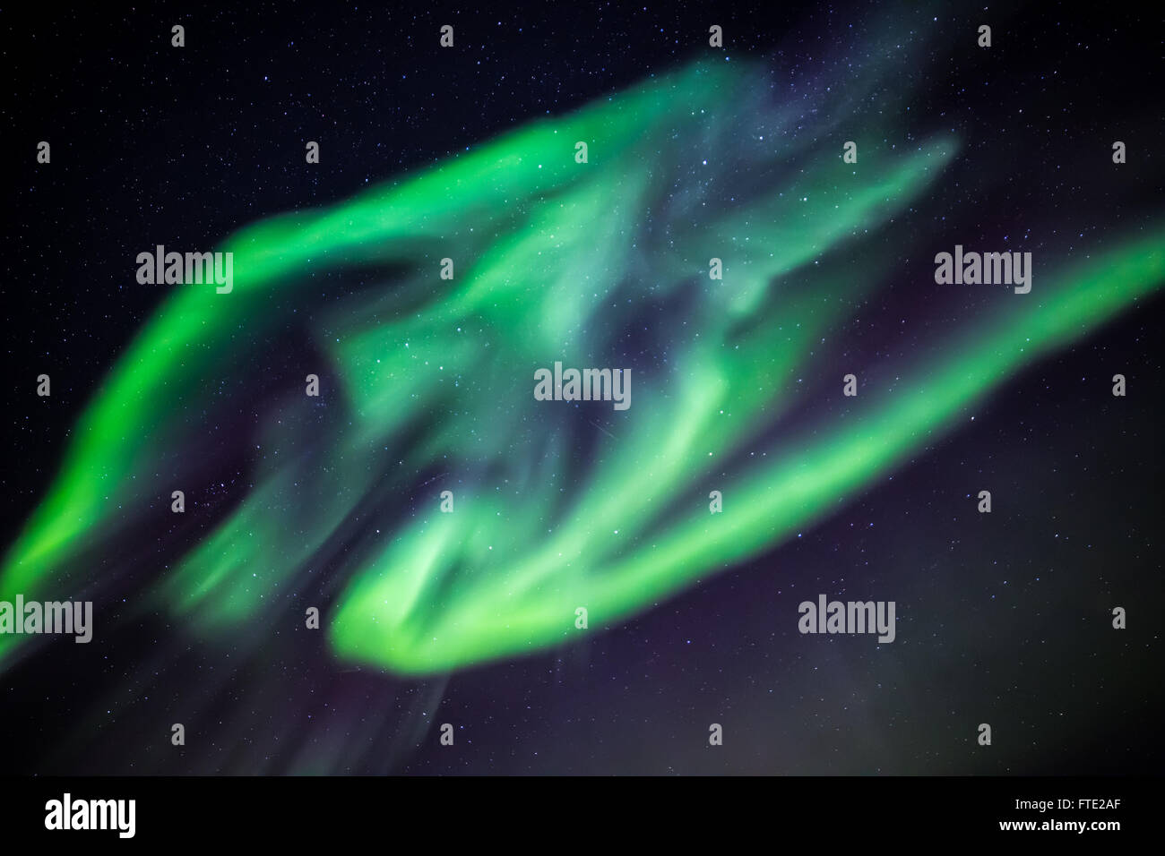 Aurora Borealis phenomenon, green extensive Northern lights over Nuuk city, Greenland, October 2015 Stock Photo
