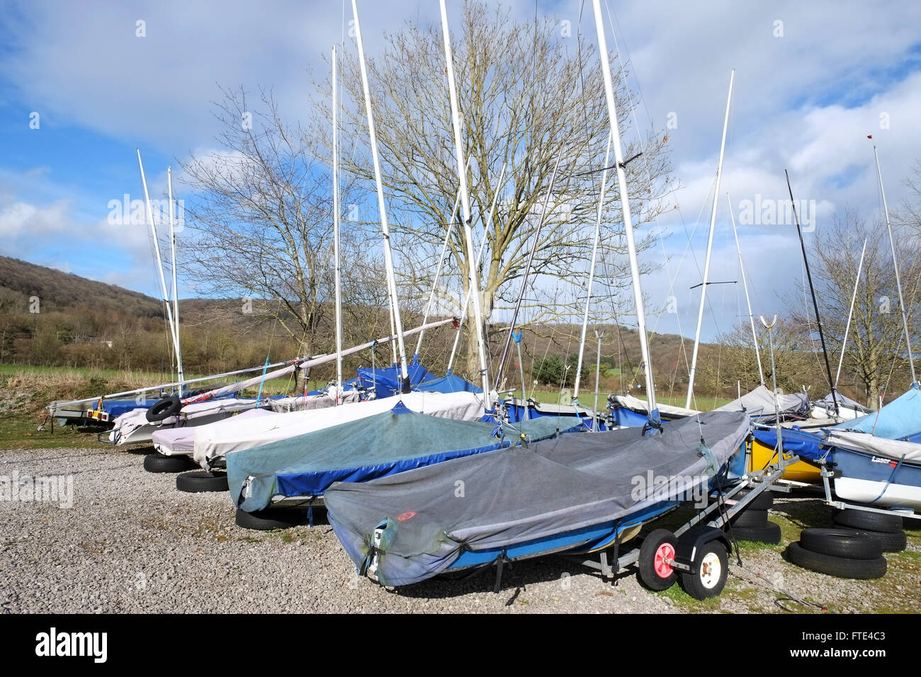 Small sailing boats and dingies on trailers in spring after being parked up for winter. 28 March 2016 Stock Photo