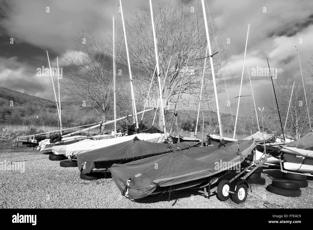 Small sailing boats and dingies on trailers in spring after being parked up for winter. 28 March 2016 Stock Photo