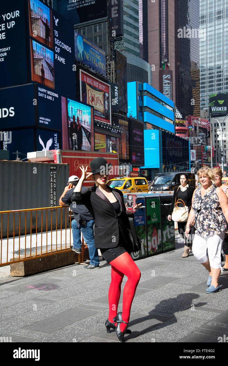 Red stockinged lady informs people where to get discount Broadway tickets TKTS at booths in nearby Duffy Square. Stock Photo