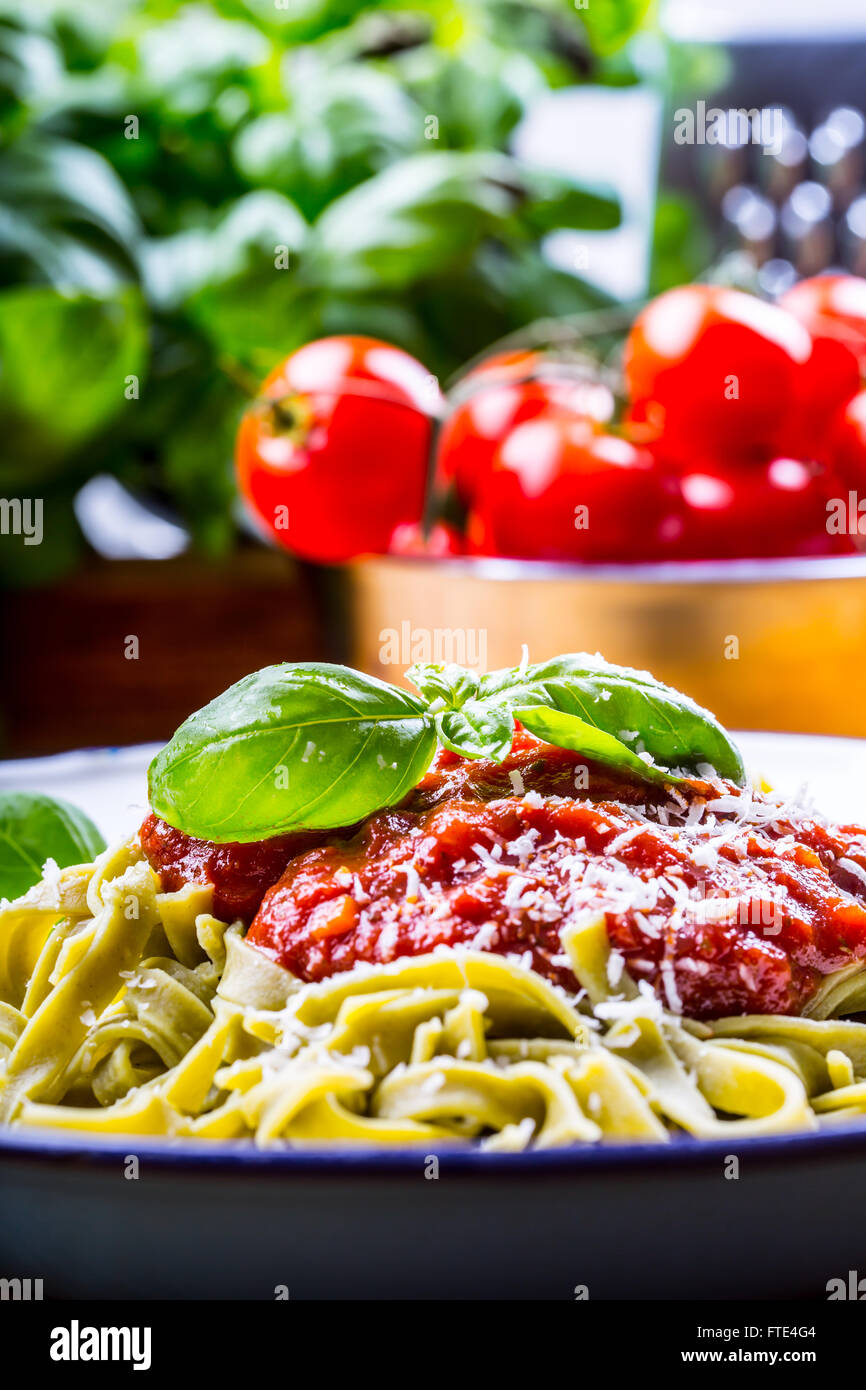 Pasta. Italian and Mediterranean cuisine. Pasta Fettuccine with tomato sauce basil leaves garlic and parmesan cheese. Stock Photo