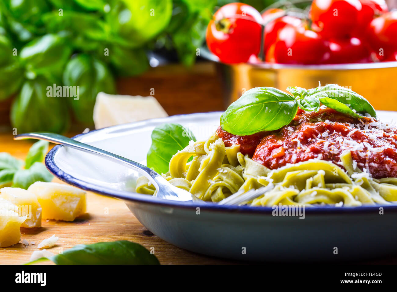 Pasta. Italian and Mediterranean cuisine. Pasta Fettuccine with tomato sauce basil leaves garlic and parmesan cheese. Stock Photo