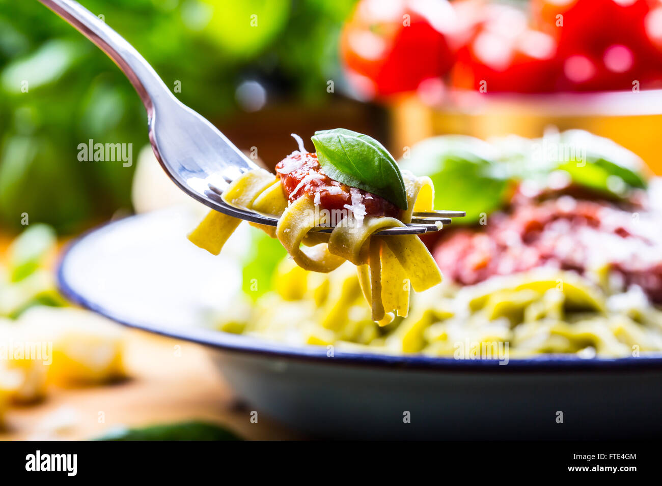 Pasta. Italian and Mediterranean cuisine. Pasta Fettuccine with tomato sauce basil leaves garlic and parmesan cheese. Stock Photo