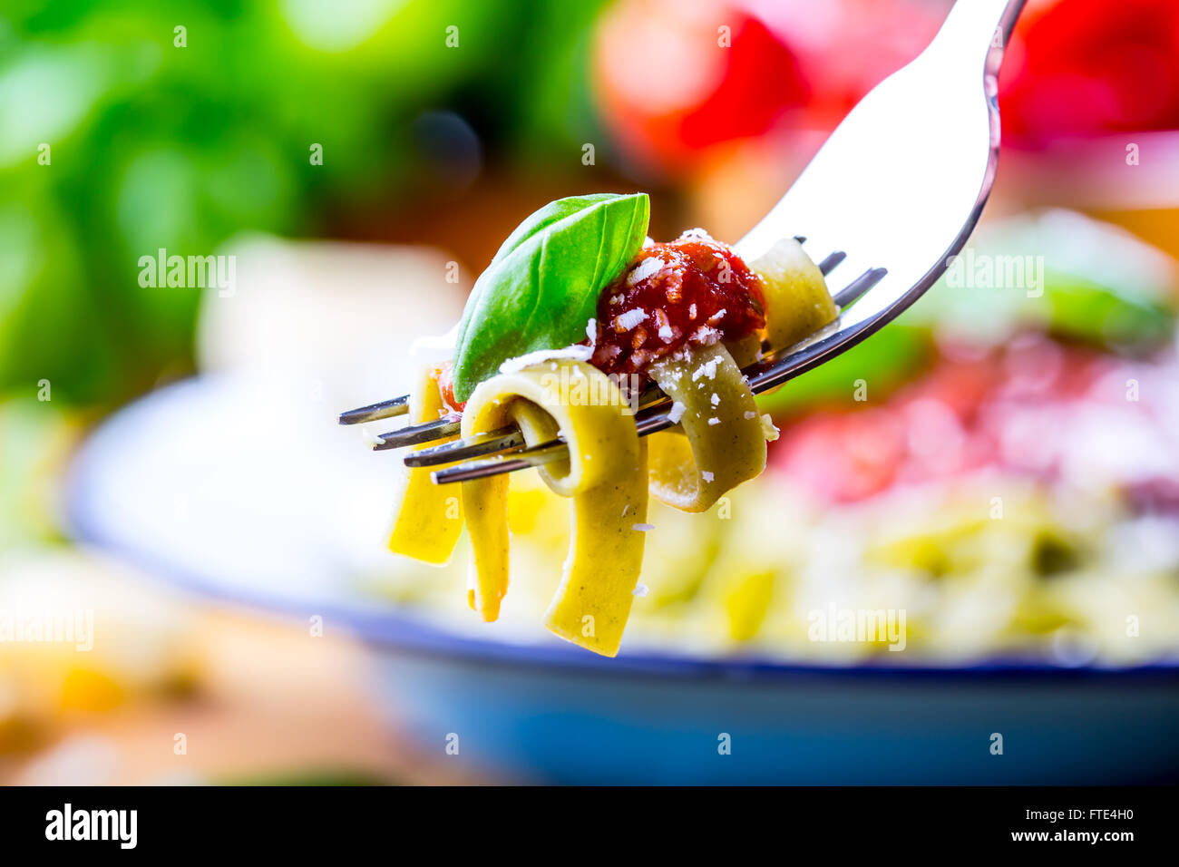 Pasta. Italian and Mediterranean cuisine. Pasta Fettuccine with tomato sauce basil leaves garlic and parmesan cheese. Stock Photo