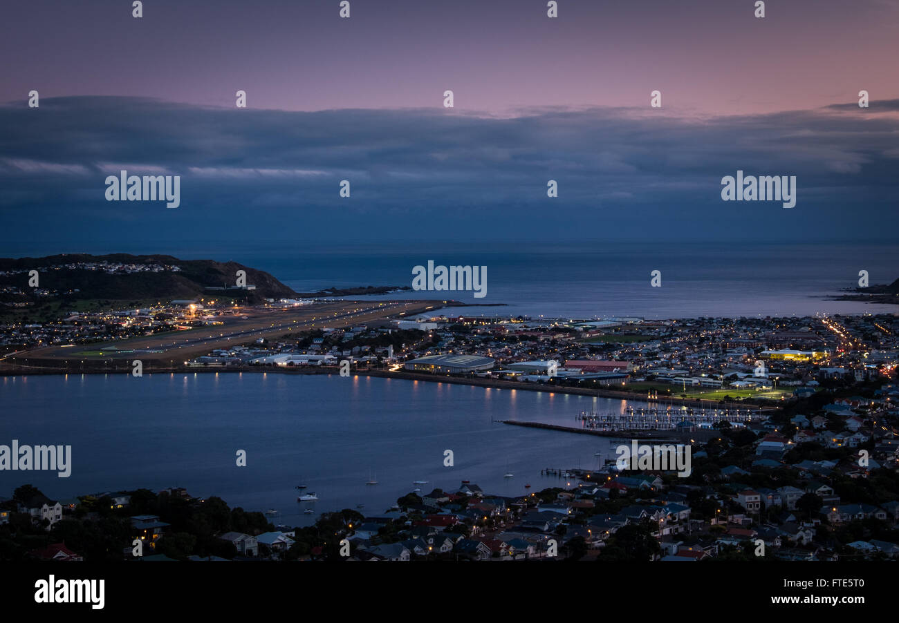 Wellington Airport (WLG) and surrounding areas of Rangotai, Lyall Bay and Kilburnie seen from Mt Victoria at dusk Stock Photo