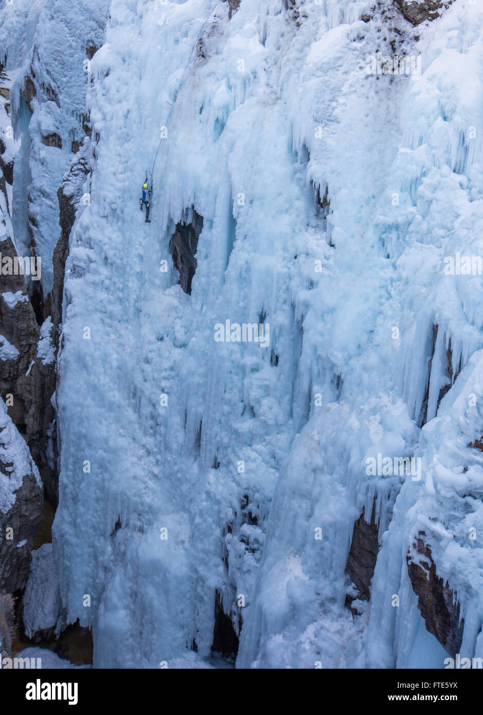 Ice climber climbing a route called Pick o' Vic which is rated WI4 in Ouray Colorado Stock Photo