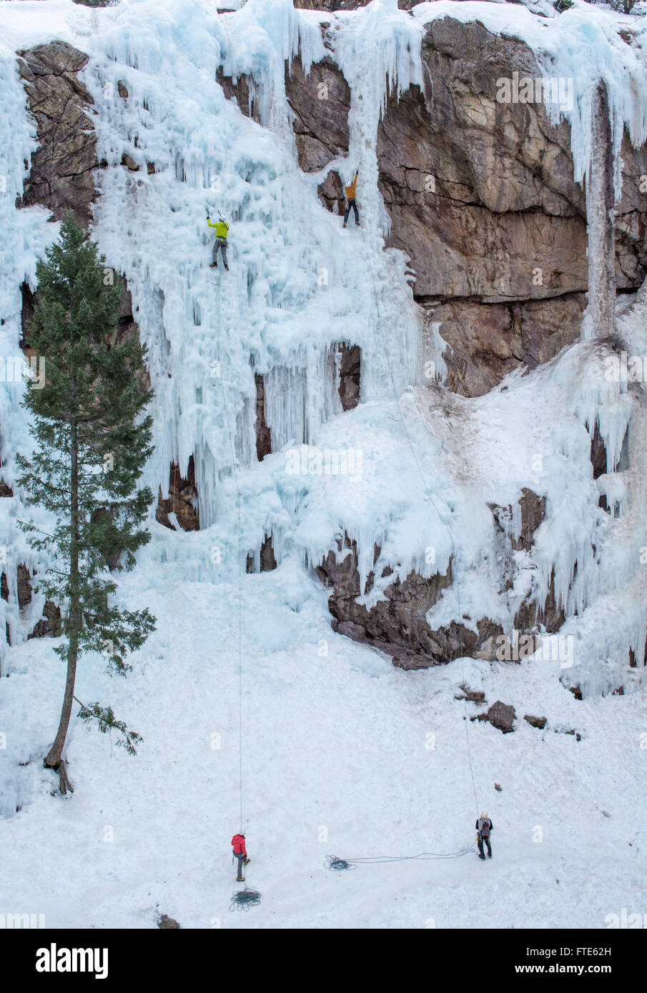 Ice climbers climbing routes called We're Number One and Up Yours rated WI5 in Colorado Stock Photo