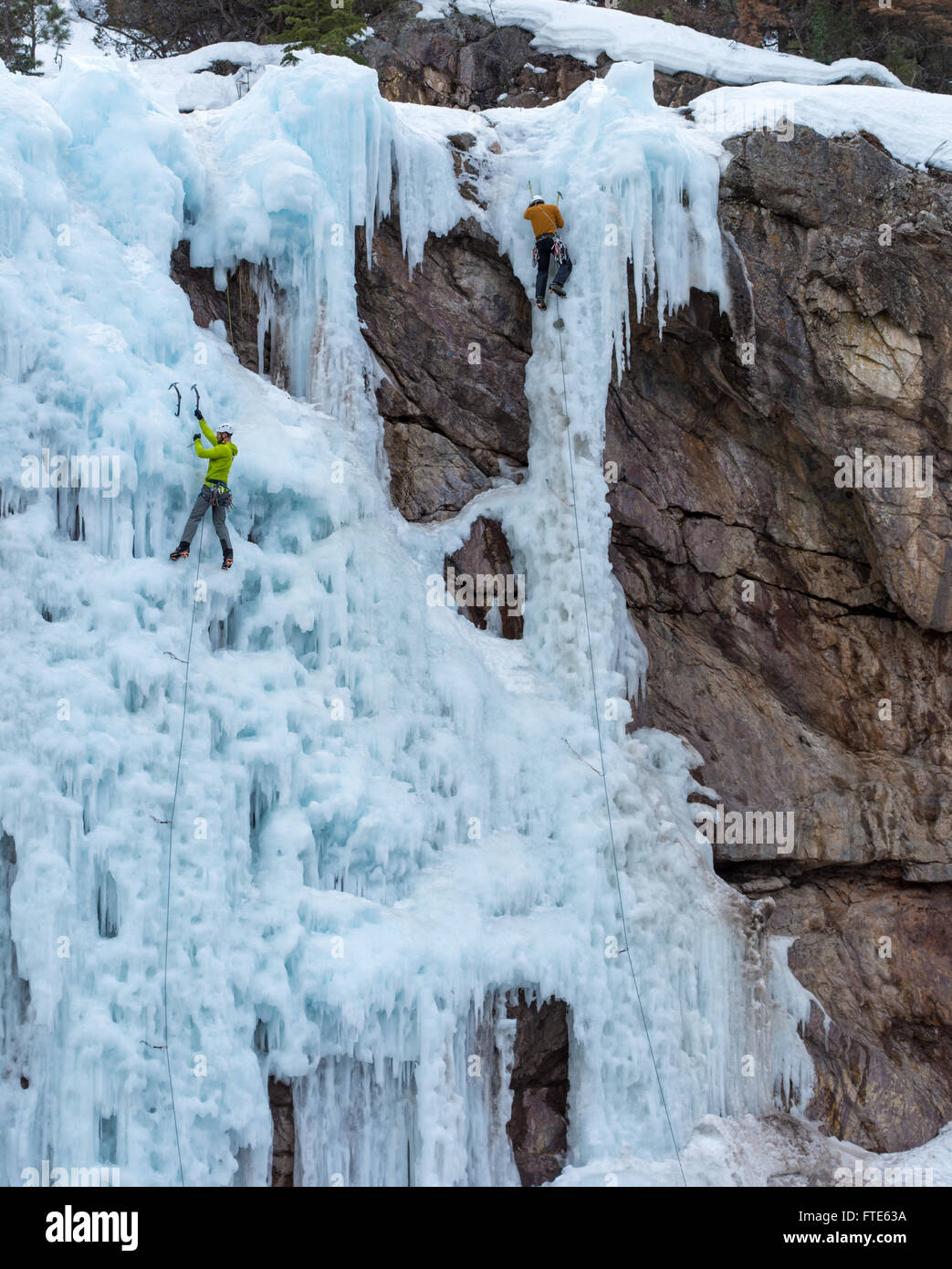 Ice climbers climb routes called 'We're Number One' and 'Up Yours' rated WI5 in the Ouray Colorado Stock Photo