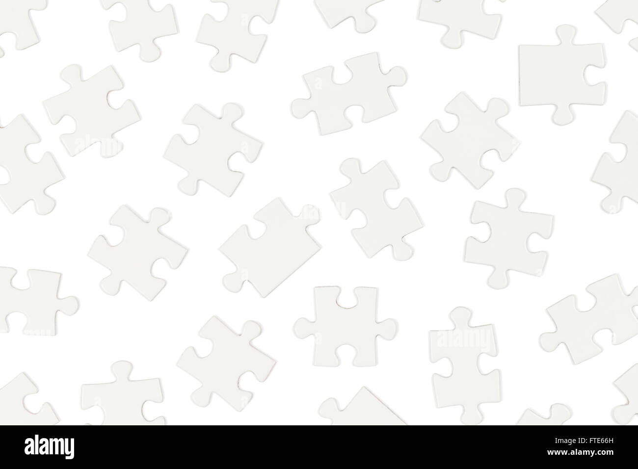 Scattered White Puzzle Pieces Isolated on White Background. Stock Photo
