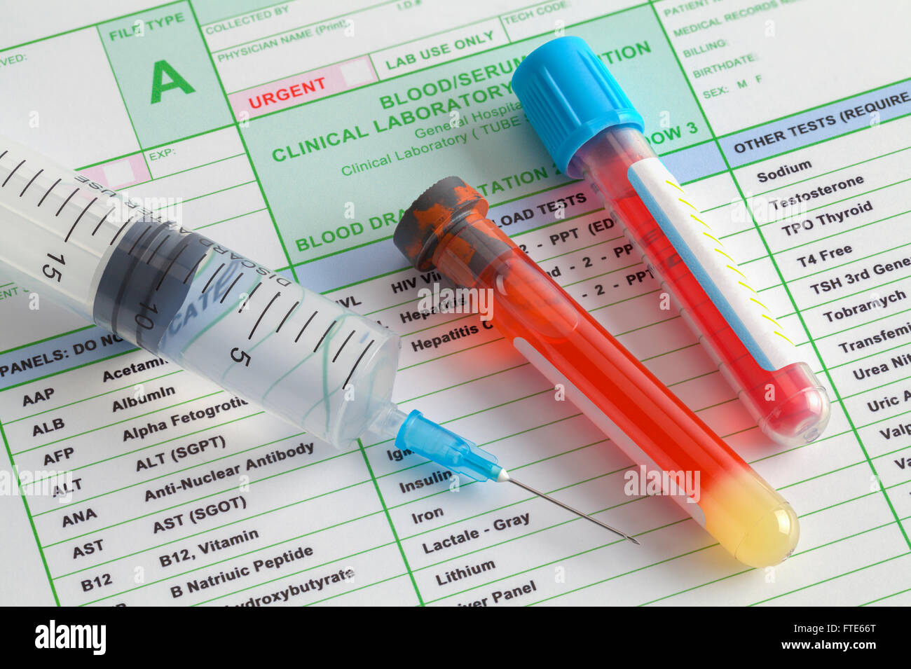Blood Vials and Syringe with Needle on Top of Lab Results. Stock Photo