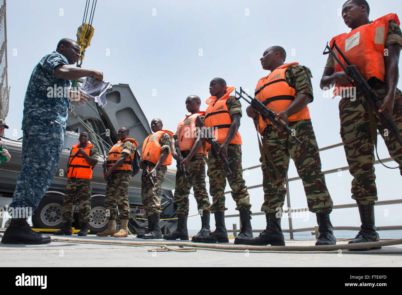 160322-N-QF605-050 GULF OF GUINEA (March 22, 2016) Aviation Boatswain's Mate (Equipment) 2nd Class Koffi Atanley, translates directions to Cameroon sailors aboard USNS Spearhead (T-EPF 1) during a boarding exercise for exercise Obangame/Saharan Express 2016, March 22. Obangame/Saharan Express, one of three African regional express series exercises facilitated by U.S. Naval Forces Europe-Africa/U.S. 6th Fleet, seeks to increase regional cooperation, maritime domain awareness, information sharing practices and improve interoperability among participating forces in order to enhance maritime secur Stock Photo