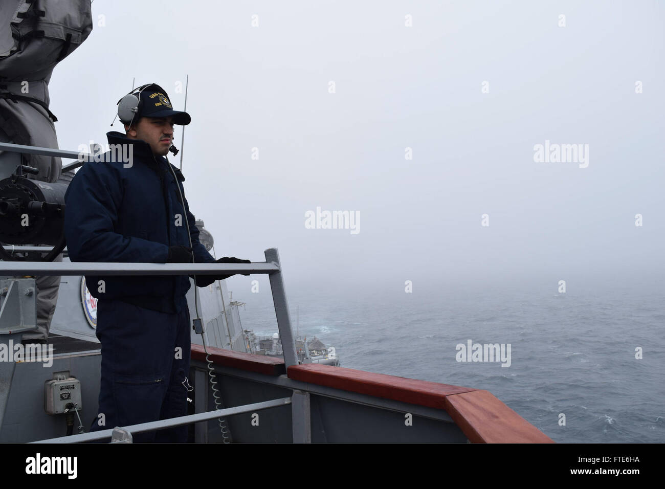 151118-N-ZT773-003 ATLANTIC OCEAN (Nov. 18, 2015) Ship’s Serviceman 2nd  Class Isaac Payne of Elyira, Ohio, stands as low visibility lookout aboard USS Carney (DDG 64) Nov. 18, 2015. Carney, an Arleigh Burke-class guided-missile destroyer, forward deployed to Rota, Spain, is conducting a routine patrol in the U.S. 6th Fleet area of operations in support of U.S. national security interests in Europe. (U.S. Navy photo by Lt. j.g. Jessica Bronson/ Released) Stock Photo