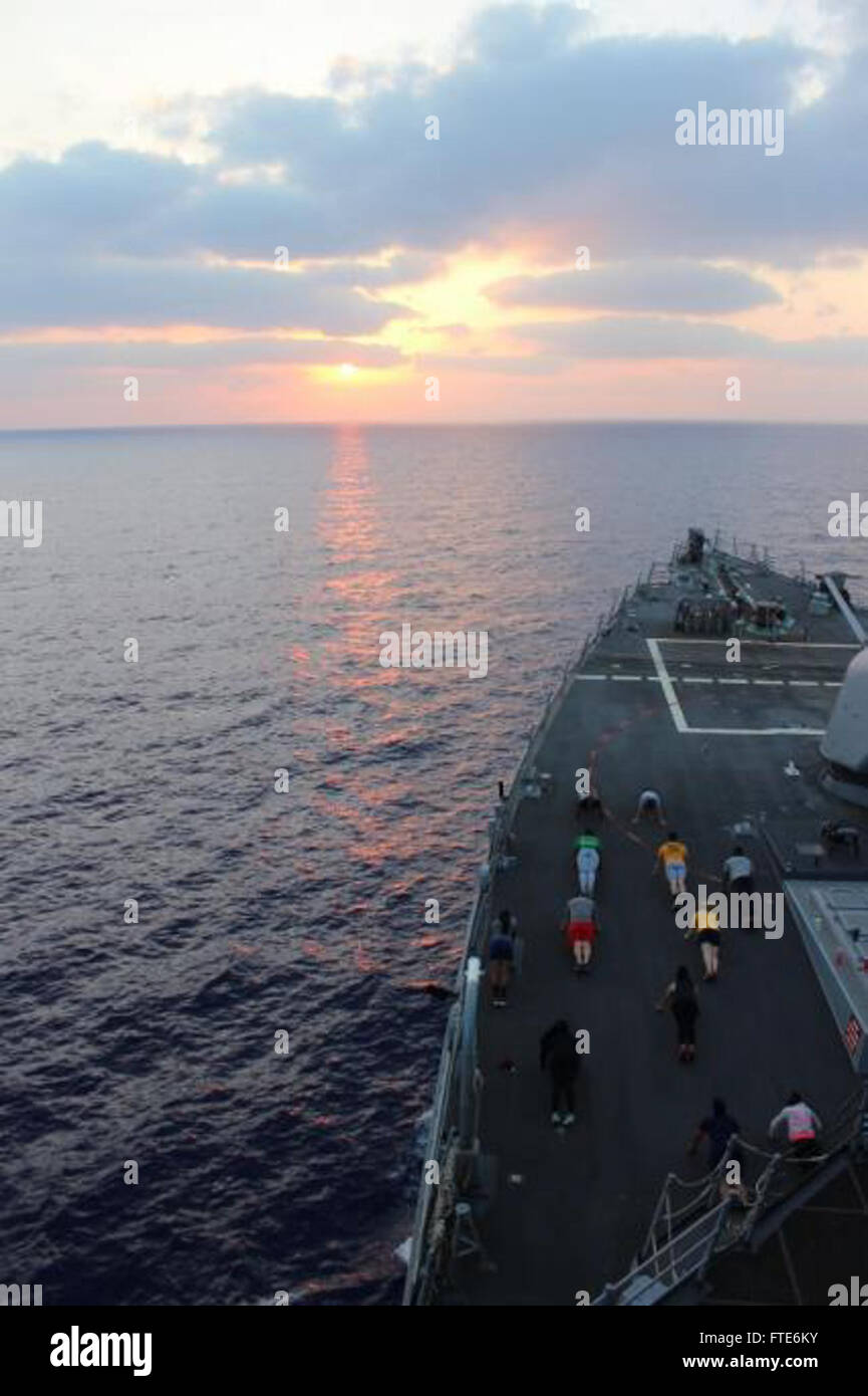 150724-N-ZZ999-001 MEDITERRANEAN SEA (July 24, 2015) Sailors aboard USS Porter (DDG 78) take advantage of the cool weather and sunset for some evening fitness training, July 24, 2015. Porter, an Arleigh Burke-class guided missile destroyer, forward-deployed to Rota, Spain, is on a routine patrol conducting naval operations in the U.S. 6th Fleet area of operations in support of U.S. national security interests in Europe. (U.S. Navy photo by Lt. j.g. Laura Adams/Released) Stock Photo