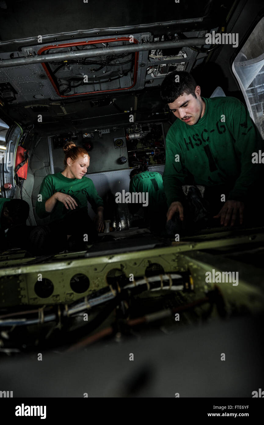 Aviation Structural Mechanic 3rd Class Emilie Hayes, left, and Aviation Structural Mechanic 3rd Class Michael McCollum, perform maintenance on an MH-60S Seahawk helicopter, assigned to the “Indians” of Helicopter Sea Combat Squadron (HSC) 6, in the hangar bay on board the aircraft carrier USS Nimitz (CVN 68). Nimitz is deployed supporting maritime security operations and theater security cooperation efforts in the U.S. 6th Fleet area of operations. (U.S. Navy photo by Mass Communication Specialist Seaman Siobhana R. McEwen/ Released) Stock Photo