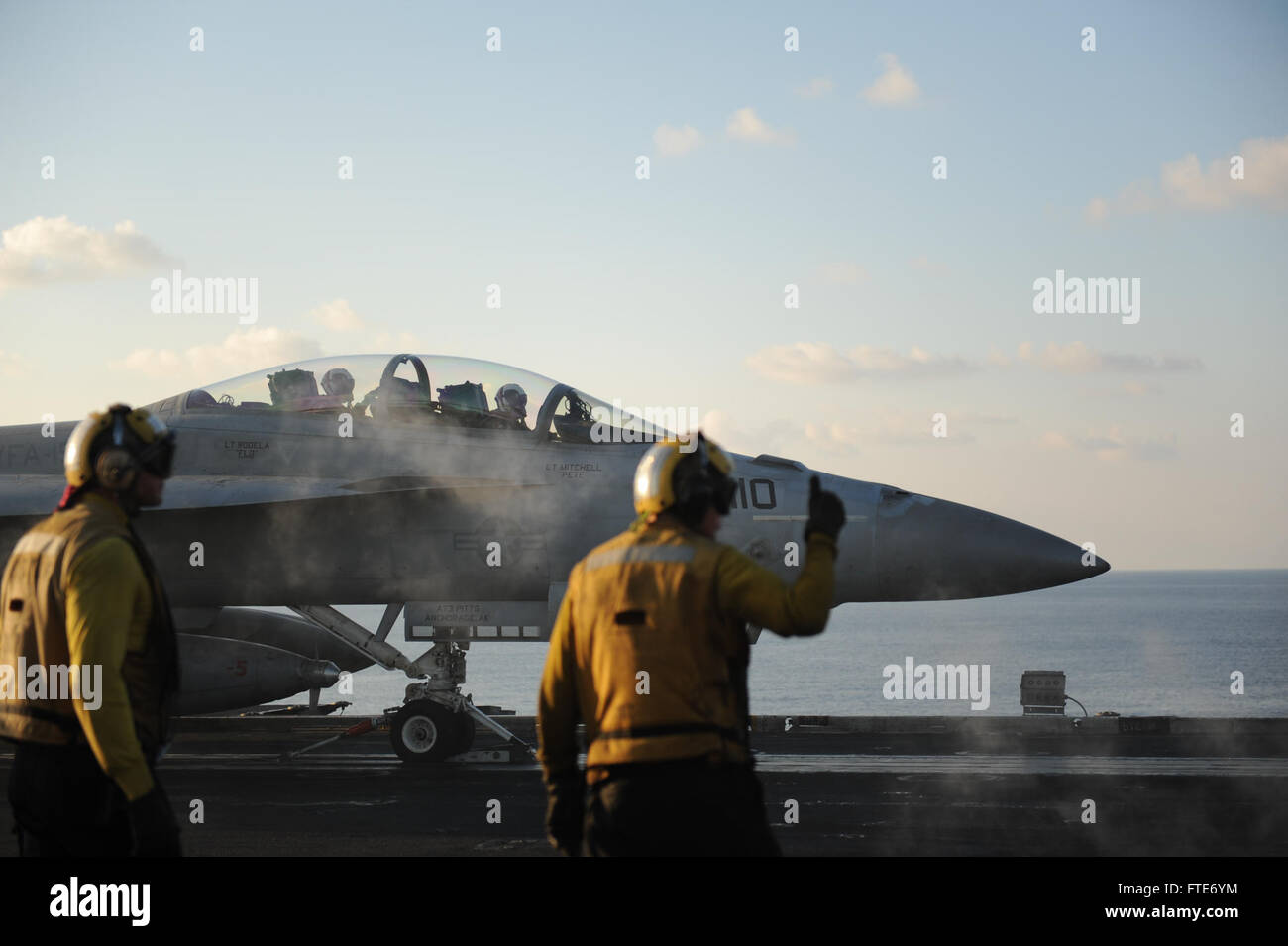 Sailors prepare an F/A-18F Super Hornet, assigned to the “Black Knights” of Strike Fighter Squadron (VFA) 154, for launch from the flight deck of the aircraft carrier USS Nimitz (CVN 68). Nimitz is deployed supporting maritime security operations and theater security cooperation efforts in the U.S. 6th Fleet area of operations. (U.S. Navy photo by Mass Communication Specialist Seaman Siobhana R. McEwen/ Released) Stock Photo